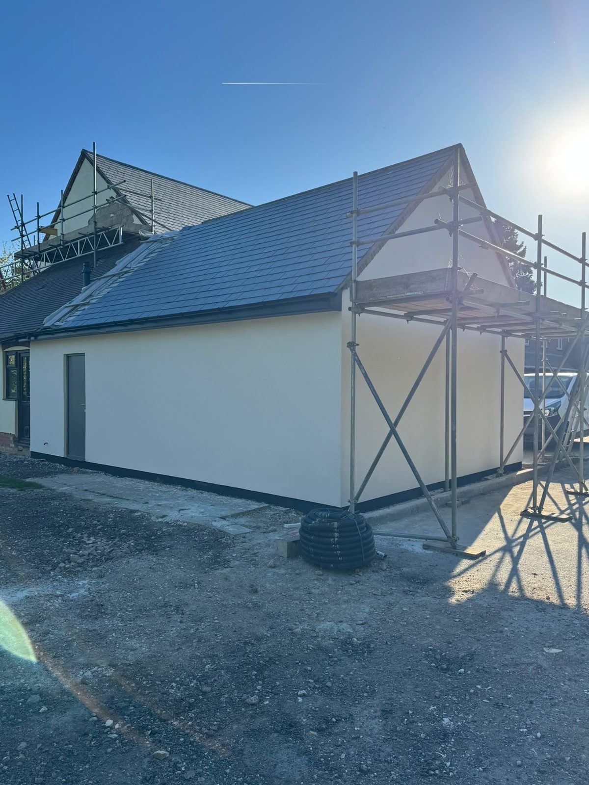Freshly rendered extension gable in evening light