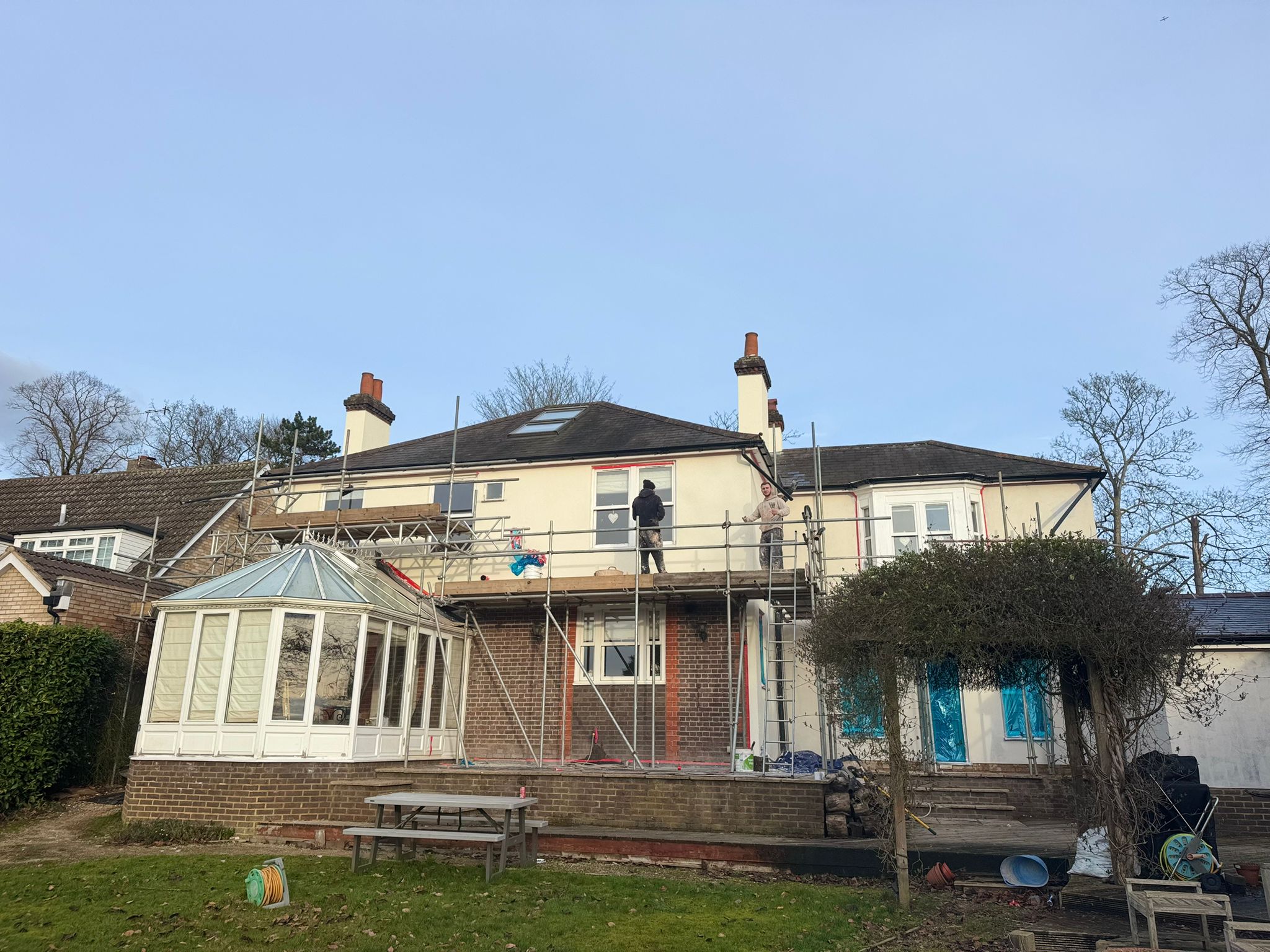 The team preparing a large property for insulation and render