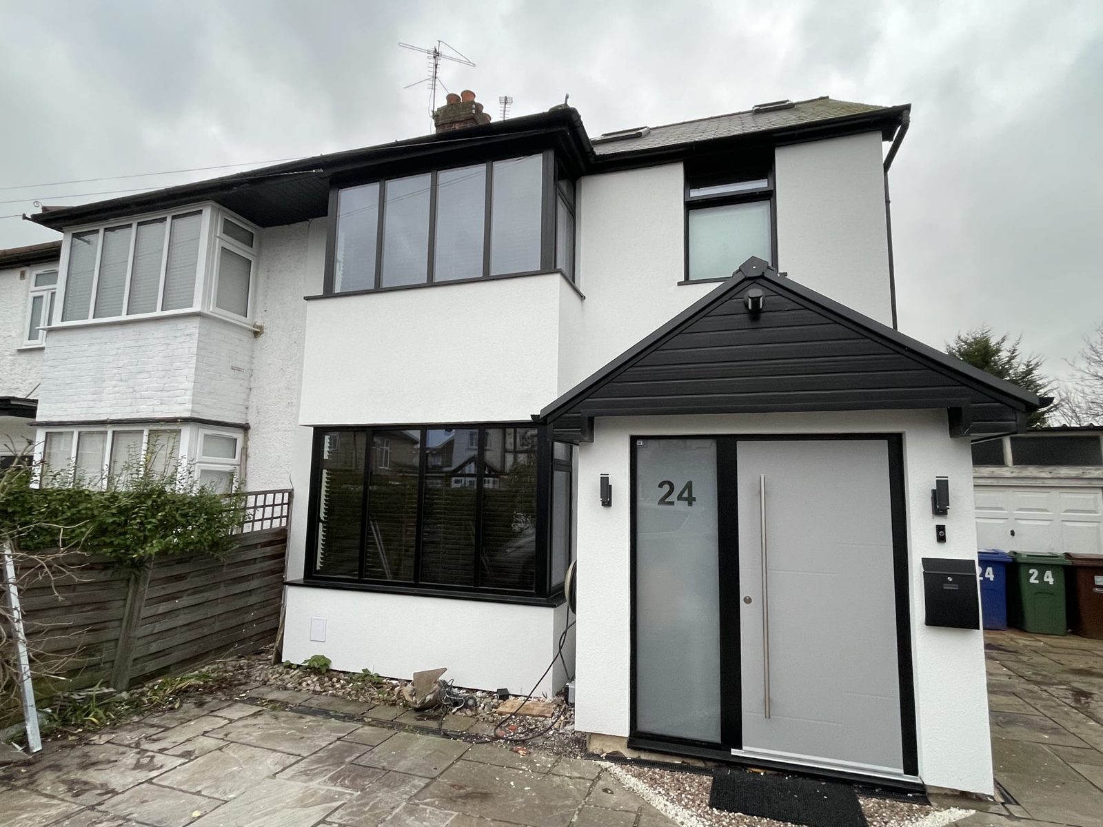 Completed white silicone render on a modernised semi-detached house