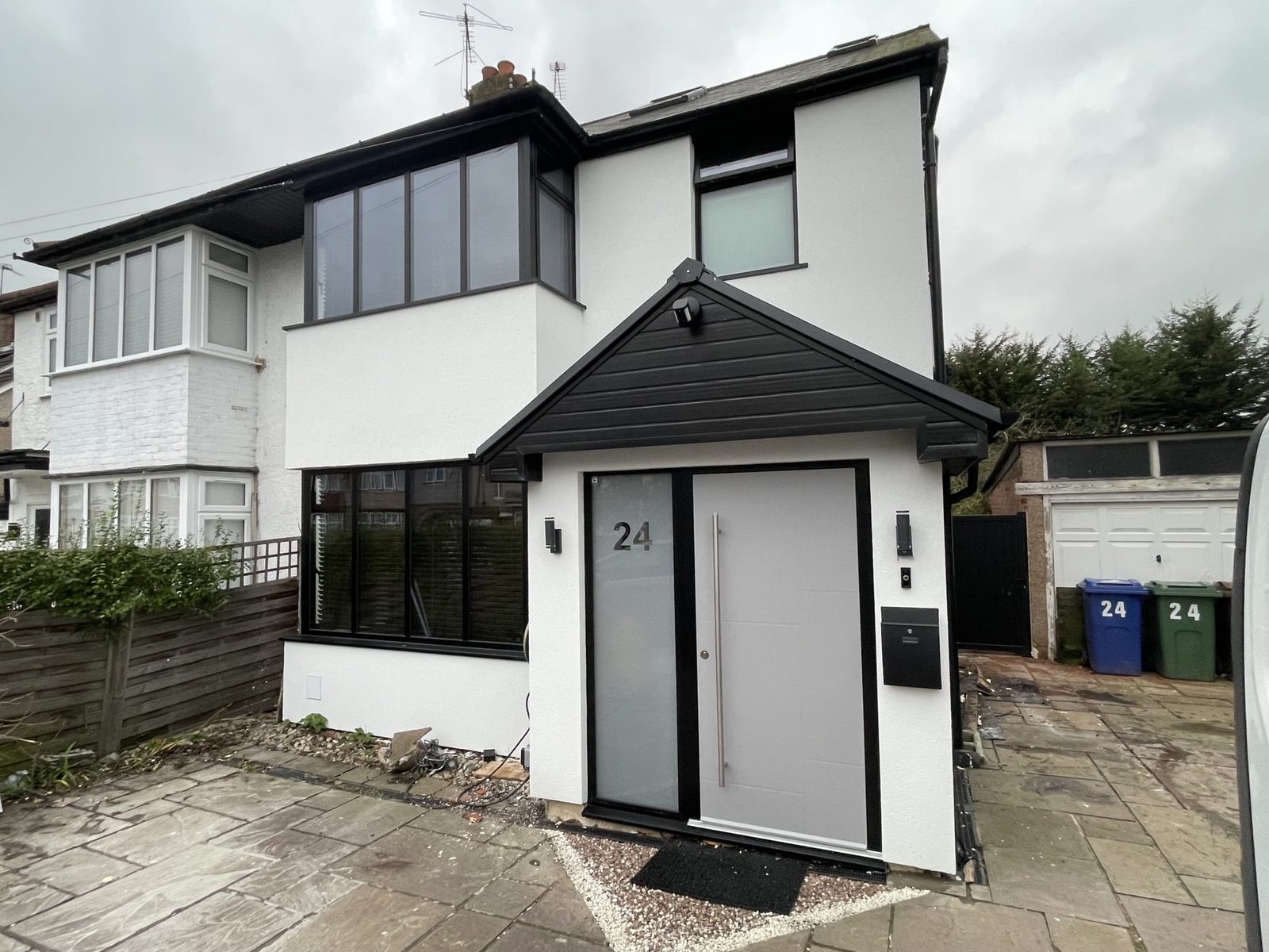 Freshly rendered semi-detached house with contrasting black porch canopy