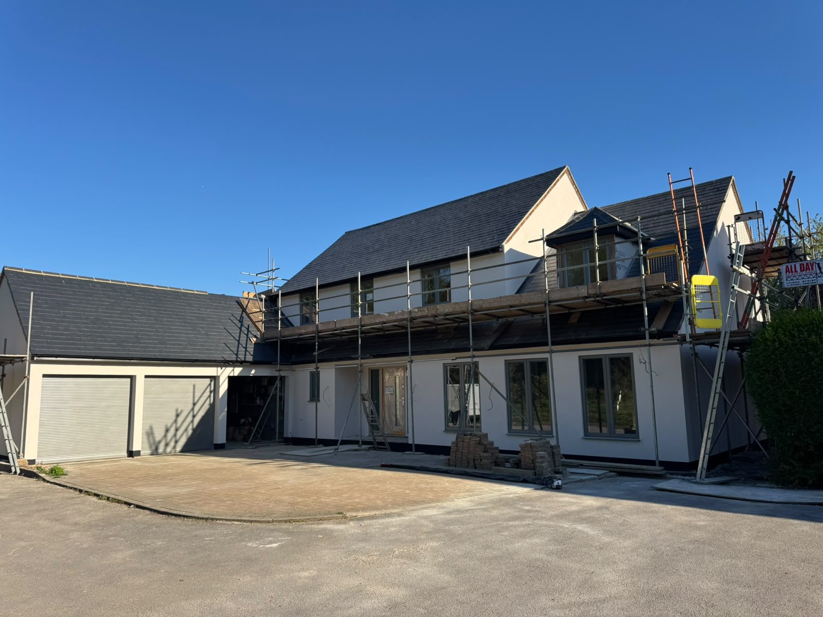 The same house finished in white render over insulation